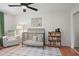 Bright Bedroom with wood floor, crib and cozy armchair at 124 Hunters Mill Rd, Woodstock, GA 30188