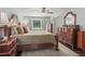Comfortable bedroom featuring wood furniture, a ceiling fan, and soft natural light at 124 Hunters Mill Rd, Woodstock, GA 30188