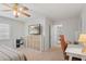 Bedroom featuring ceiling fan, shelving, and a cozy desk area at 124 Hunters Mill Rd, Woodstock, GA 30188