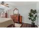 Bedroom with a ceiling fan, hardwood floors, and vintage wooden dressers at 124 Hunters Mill Rd, Woodstock, GA 30188
