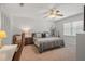 Bedroom with neutral colored walls, ceiling fan, and a large bed at 124 Hunters Mill Rd, Woodstock, GA 30188