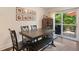 Dining area with a large table and bench seating, and glass door to backyard deck at 124 Hunters Mill Rd, Woodstock, GA 30188