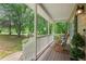 Relaxing front porch featuring rocking chairs, offering a tranquil outdoor space with views of the landscaped yard at 124 Hunters Mill Rd, Woodstock, GA 30188
