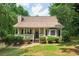 Charming single-Gathering home with a welcoming front porch and lush landscaping, creating a serene curb appeal at 124 Hunters Mill Rd, Woodstock, GA 30188