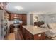 Well-lit kitchen with stainless steel appliances, a center island, and dark wood cabinets at 124 Hunters Mill Rd, Woodstock, GA 30188