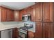 Well-equipped kitchen featuring stainless steel appliances and dark wood cabinetry at 124 Hunters Mill Rd, Woodstock, GA 30188