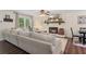 Comfortable living room with a cozy fireplace and large sectional sofa, ideal for relaxing and entertaining guests at 124 Hunters Mill Rd, Woodstock, GA 30188