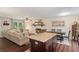 Open-concept living room with a fireplace, dining area, and kitchen island at 124 Hunters Mill Rd, Woodstock, GA 30188