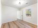 Bright bedroom with light wood flooring, window, and overhead lighting at 1783 Big Valley Ln, Stone Mountain, GA 30083