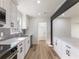 Modern kitchen features stainless appliances, gray backsplash, and ample white cabinetry at 1783 Big Valley Ln, Stone Mountain, GA 30083