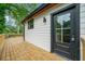 Side of the house with an outdoor deck showing the exterior door and modern design at 2822 Waters Sw Rd, Atlanta, GA 30354