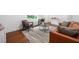 Finished basement seating area featuring a leather couch, modern rug, and hardwood floors at 2822 Waters Sw Rd, Atlanta, GA 30354