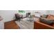 Basement living area with a leather sofa, accent chairs, and a decorative rug at 2822 Waters Sw Rd, Atlanta, GA 30354