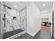 Modern bathroom features a walk-in shower with black matte fixtures and marble tiling at 2822 Waters Sw Rd, Atlanta, GA 30354