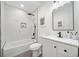Modern bathroom with a shower over tub, marble-like tile surround, and a sleek vanity at 2822 Waters Sw Rd, Atlanta, GA 30354