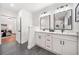 Modern bathroom features double vanities, tiled floors, and light fixtures at 2822 Waters Sw Rd, Atlanta, GA 30354