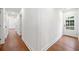 Bright hallway with hardwood floors and white walls, leading to an exterior door at 2822 Waters Sw Rd, Atlanta, GA 30354