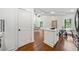 Open-concept living space with kitchen island and modern appliances, flowing into the dining area at 2822 Waters Sw Rd, Atlanta, GA 30354