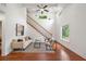 Bright living room featuring hardwood floors, vaulted ceiling, and a staircase with stylish decor at 2822 Waters Sw Rd, Atlanta, GA 30354