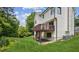Spacious backyard showcasing the home's exterior, deck, and a green lawn with surrounding trees at 2907 Wickford Dr, Kennesaw, GA 30152