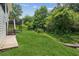 Scenic backyard with a lush lawn, mature trees, and a wooden deck at 2907 Wickford Dr, Kennesaw, GA 30152