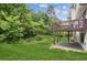 Lush backyard featuring a well-maintained lawn, mature trees, and a wooden deck at 2907 Wickford Dr, Kennesaw, GA 30152
