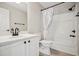 Well-lit bathroom featuring a single sink vanity, toilet, and a shower-tub combination with a shower curtain at 2907 Wickford Dr, Kennesaw, GA 30152