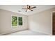 Carpeted bedroom with a ceiling fan and natural light streaming in through a bright window at 2907 Wickford Dr, Kennesaw, GA 30152