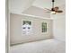 Bright bedroom with a modern ceiling fan and abundant natural light from large windows at 2907 Wickford Dr, Kennesaw, GA 30152