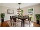 Dining room features hardwood floors, large windows, modern lighting, and room to gather at 2907 Wickford Dr, Kennesaw, GA 30152