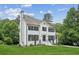 A beautiful two-story home with white brick, black shutters, and lush greenery at 2907 Wickford Dr, Kennesaw, GA 30152