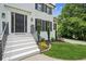 Close up of a well-maintained front entrance to a white brick home with a black front door at 2907 Wickford Dr, Kennesaw, GA 30152