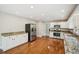 A kitchen offers white cabinets, granite countertops, stainless steel appliances, and hardwood flooring at 2907 Wickford Dr, Kennesaw, GA 30152
