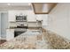 This kitchen features granite countertops, a stainless steel sink and appliances, and white cabinetry at 2907 Wickford Dr, Kennesaw, GA 30152