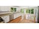 A spacious kitchen features white cabinetry, granite countertops, stainless steel appliances, and wood floors at 2907 Wickford Dr, Kennesaw, GA 30152