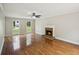 Cozy living room with hardwood floors, fireplace, and large windows at 2907 Wickford Dr, Kennesaw, GA 30152