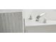 Close-up of a modern white bathtub with chrome faucet and mosaic tile surround at 2907 Wickford Dr, Kennesaw, GA 30152