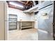 Unfinished basement with exposed ceiling, utility connections, shelving and work bench at 5287 Vernon Lake Dr, Atlanta, GA 30338