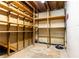 Unfinished basement with unfinished walls and ceiling and wooden shelving for storage at 5287 Vernon Lake Dr, Atlanta, GA 30338