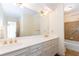 Bathroom featuring double vanity, gold fixtures, and tiled shower at 5287 Vernon Lake Dr, Atlanta, GA 30338
