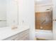 Well-lit bathroom features a vanity and a shower with a tiled wall and a handrail at 5287 Vernon Lake Dr, Atlanta, GA 30338