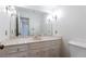 Bathroom with marble countertop vanity, elegant lighting, and brushed gold fixtures at 5287 Vernon Lake Dr, Atlanta, GA 30338
