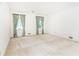 Spacious bedroom with two windows and light carpet flooring at 5287 Vernon Lake Dr, Atlanta, GA 30338
