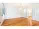Classic dining room boasts gleaming hardwood floors and vintage chandelier, ideal for entertaining at 5287 Vernon Lake Dr, Atlanta, GA 30338