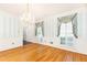 An elegant dining room showcasing hardwood floors, crown molding, and stylish window treatments at 5287 Vernon Lake Dr, Atlanta, GA 30338