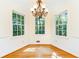 Charming dining nook with hardwood floors, chandelier, and scenic views through large windows at 5287 Vernon Lake Dr, Atlanta, GA 30338