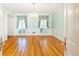 Bright dining room showcases hardwood floors, decorative windows, and charming vintage door hardware at 5287 Vernon Lake Dr, Atlanta, GA 30338
