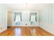 Elegant dining room featuring hardwood floors, chandelier, and natural light from bright windows at 5287 Vernon Lake Dr, Atlanta, GA 30338