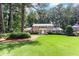 Beautiful two-story brick home boasts a lush green lawn, mature trees, and a classic design at 5287 Vernon Lake Dr, Atlanta, GA 30338
