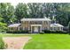 Charming brick home with a well-manicured lawn, lush landscaping, and a cozy second story balcony at 5287 Vernon Lake Dr, Atlanta, GA 30338